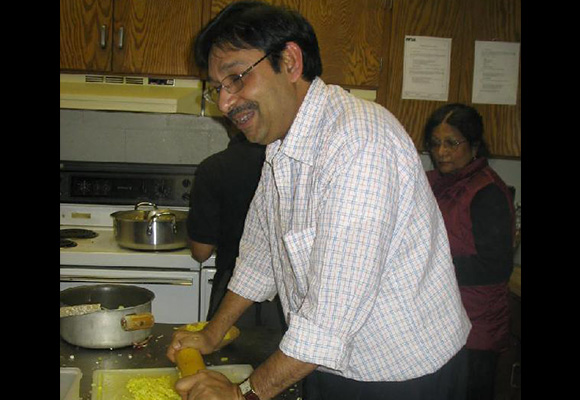 Pressing ginger saraswati pooja